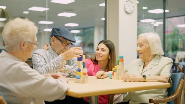 Tender nurse approaching to talk to senior people in a geriatrics