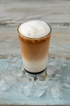 Iced coffee latte in glass cup on wooden table