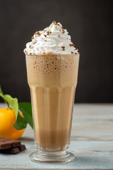 Orange and chocolate milkshake with coffee sprinkled on top