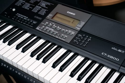 Ryazan, Russia - January 9, 2024: Modern Casio digital music keyboard. Casio Computer Co., Ltd. is a Japanese multinational electronics manufacturing corporation