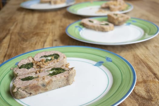 plates lined up with spinach meatloaf inside