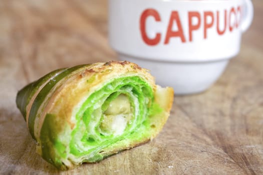 morning awakening with cappuccino and half pistachio croissant  