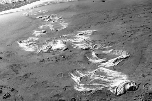 shapes and patterns made from waste on a sea beach