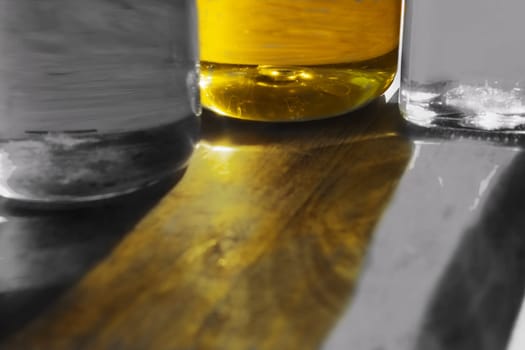 colorful reflections of some bottles on a wooden table