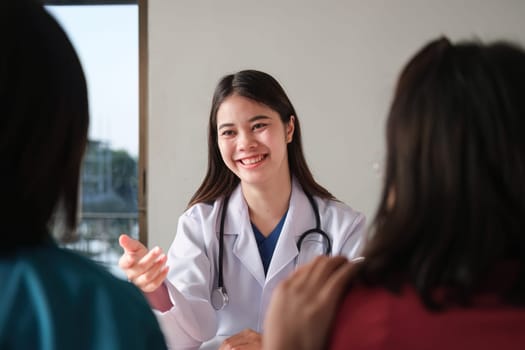 An Asian female doctor is consulting a patient who comes to discuss taking medication for health care. and treat disease with medicine.