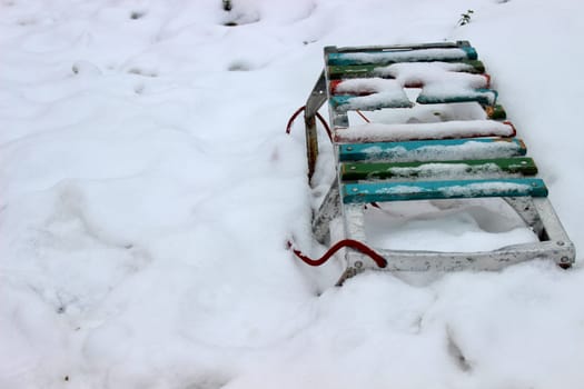 Children's wooden sled in the yard in winter on snow. High quality photo