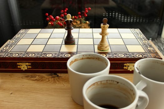 Three empty coffee cups on a checkerboard background. High quality photo