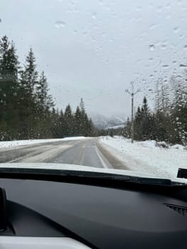 View from the windshield of the car on the road and rainy winter weather. High quality photo