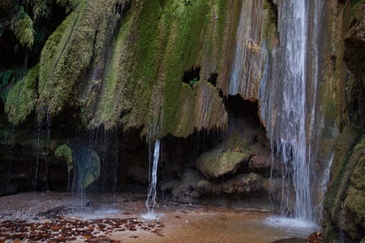 Waterfall in the autumn forest. Autumn forest waterfall. Autumn waterfall in autumn forest. Waterfall landscape. High quality photo