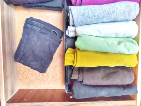 Tidy and organized clothes with the konmari method. Storage of T-shirts folded in box