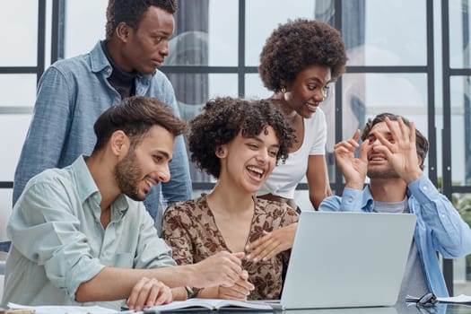 Employees working at computer together