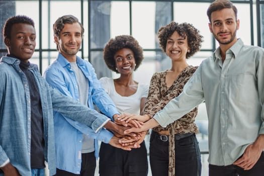 group of successful business diverse people in the office stands embracing