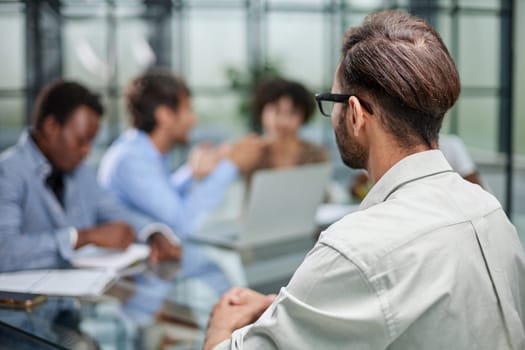 business man with executives working in background in office