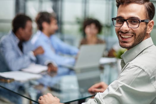 business man with executives working in background in office