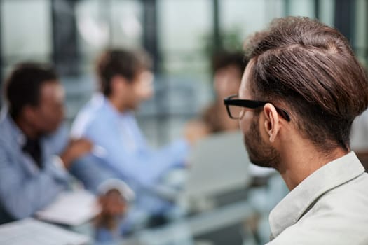 business man with executives working in background in office