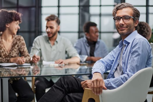 business man with executives working in background in office