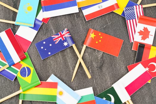 Policy. National flags of different countries. The concept is diplomacy. In the middle among the various flags are two flags - China, Australia