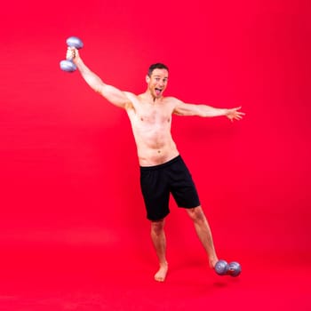 Man, dumbbell and exercise in a studio for fitness, wellness and healthy body with workout training.