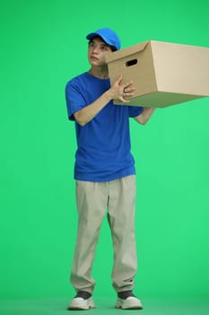 The delivery guy, on a green background, in full height, shakes the box.