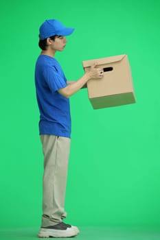 The delivery guy, on a green background, full-length, with a box.