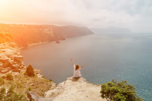 Woman travel summer sea. Portrait of a happy woman on a background of beautiful sea. Rear view of a woman in a white shirt. Freedom and happiness.