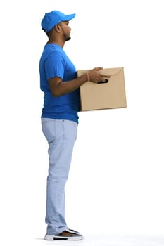 A male deliveryman with a box, on a white background, full-length, in profile.