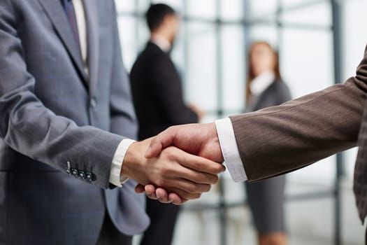 Nice to meet you. Close-up of two young businessmen shaking hands