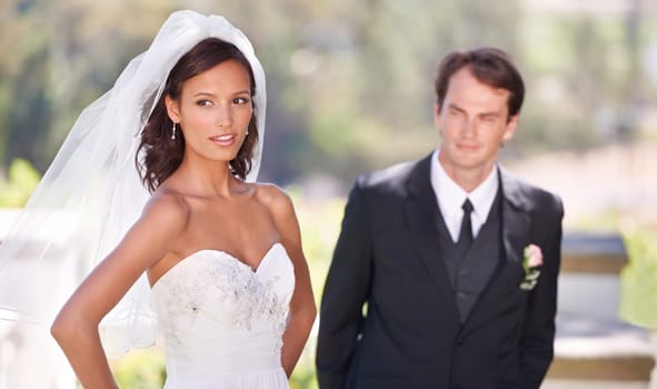 Couple, happy and love on wedding day in outdoors, together and excited for marriage and commitment. People, romance and union at outside ceremony, loyalty and pride for fashion and partnership.