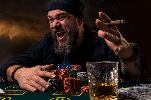 Man is playing poker. Emotional fail in game, game over for card player, man very angry with foolish choices, losing all the chips on bank. Concept of victory and loosing