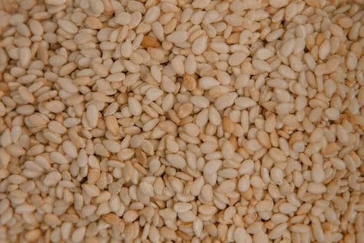 sesame seeds. Pile of white sesame seeds as background, top view.