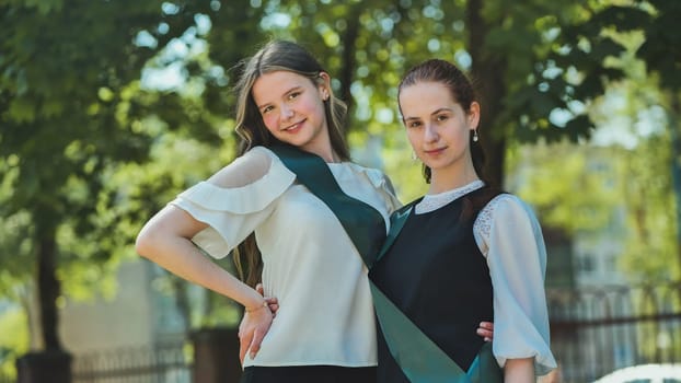 Portrait of two Russian schoolgirls graduating from high school
