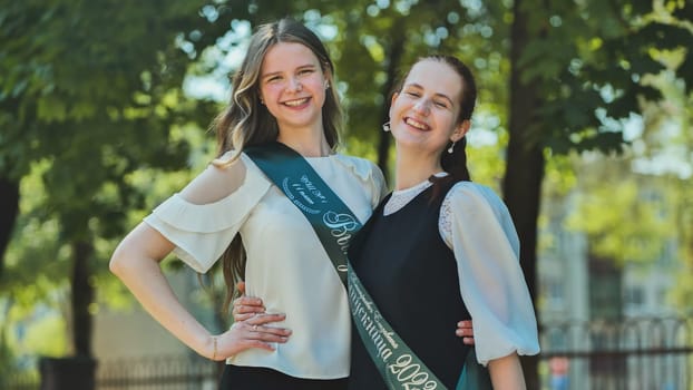 Portrait of two Russian schoolgirls graduating from high school