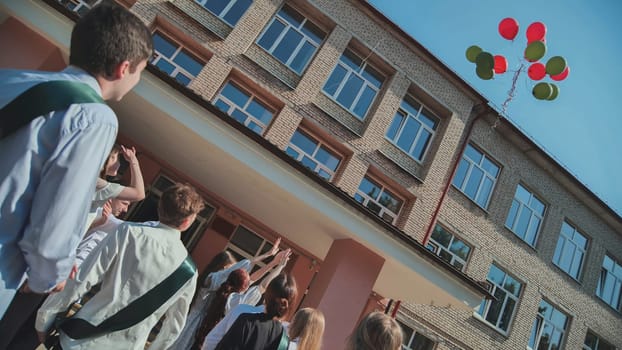 Berezovka, Belarus - May 31, 2023 High school graduates launch balloons into the sky