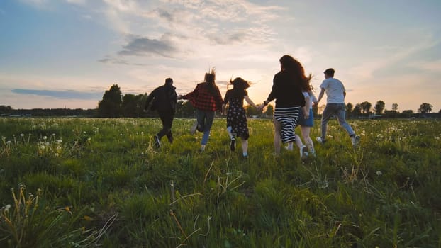 Merry friends run off into the sunset holding hands