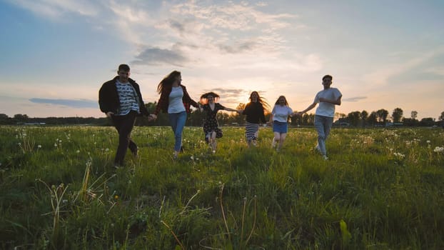 Merry friends run off into the sunset holding hands