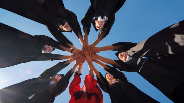 The happy graduates join hands and disperse