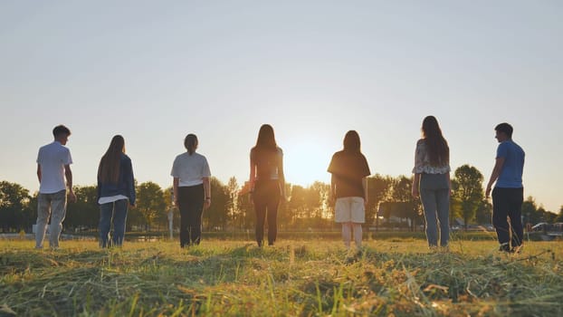 Friends standing in a meadow in the summer