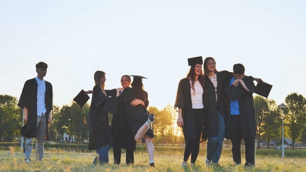 College alumni friends pose in the evening meadow