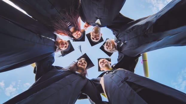 College students stand in a circle wearing black robes