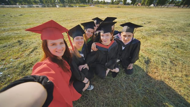 College alumni take selfies in the meadow