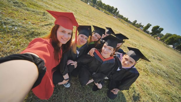 College alumni take selfies in the meadow