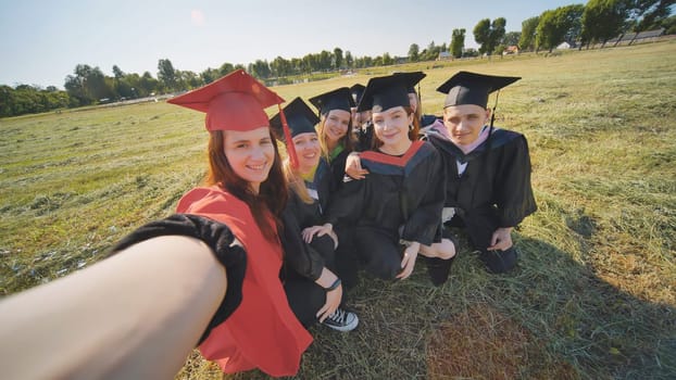 College alumni take selfies in the meadow