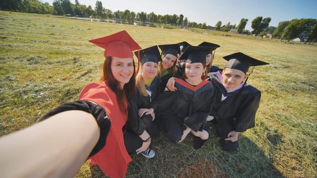 College alumni take selfies in the meadow