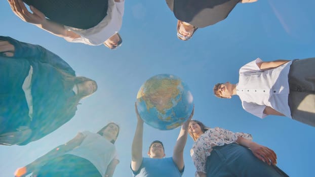 The concept of keeping the world safe. Friends holding a geographical globe in their hands