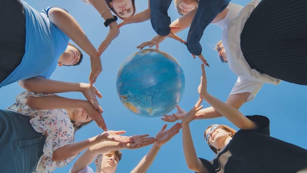 Students make a circle around the globe of the world. The concept of world peace