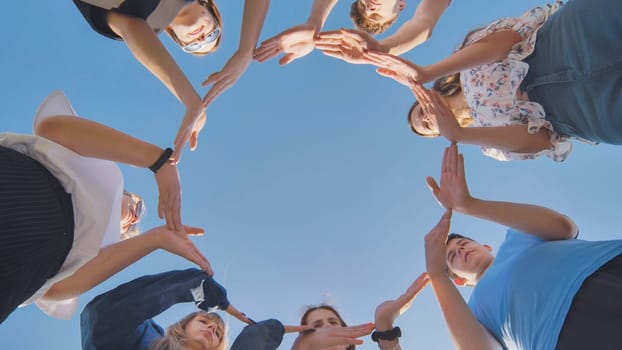 School friends make a big circle with their hands