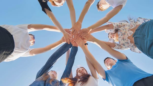 Friends putting their hands together in a sign of unity and teamwork. Just the hands