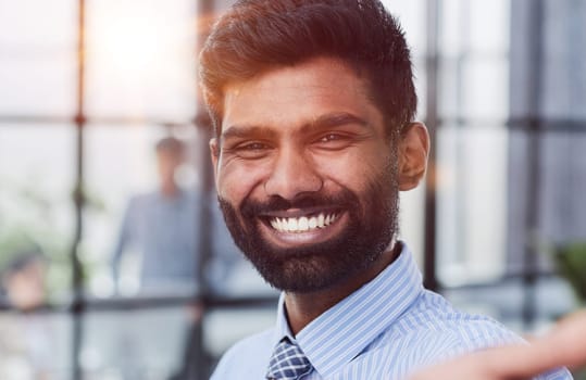 male investor beard looking at camera and smiling in modern office