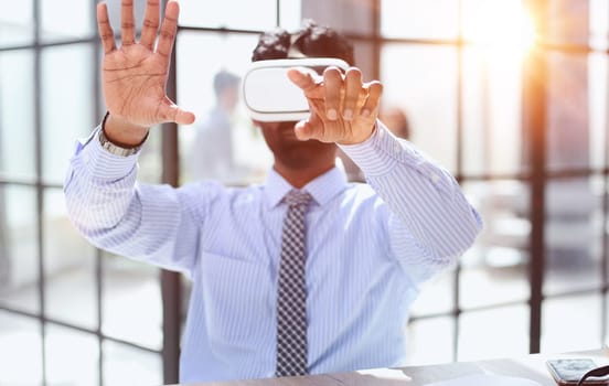 European man office employee wears formal suit and VR headset glasses excited of experiencing virtual reality