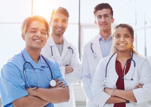 Professional Multinational Doctors Camera Posing. Teamwork Connection.